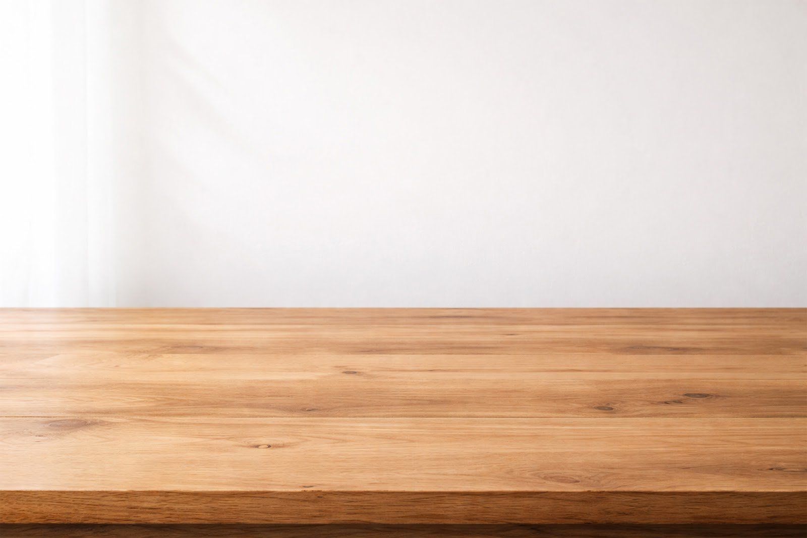Wooden Table Mockup Against White Wall with Natural Light – Free Download