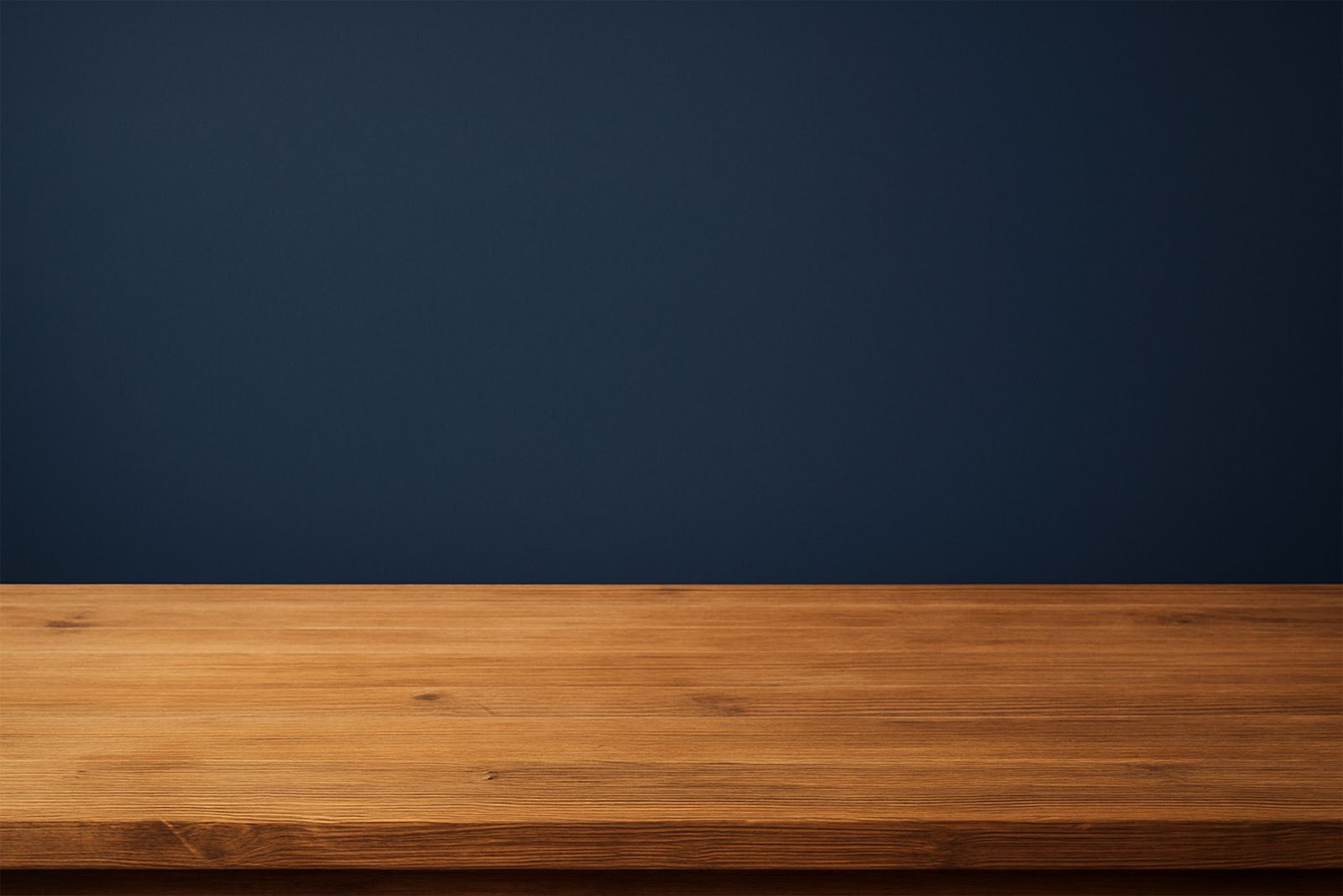 Wooden Table Mockup with Navy Blue Studio Backdrop – Free Download