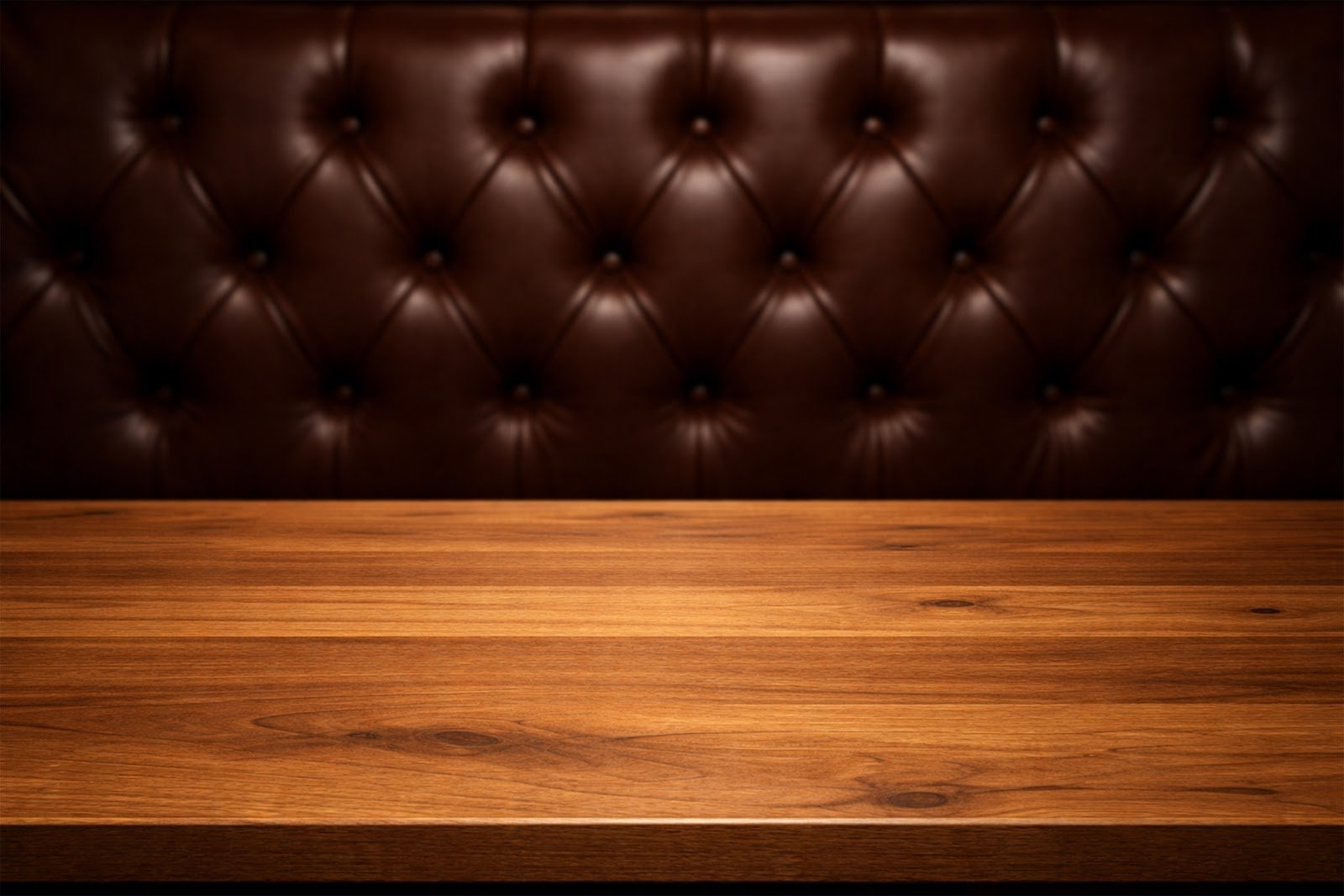 Wooden Table Mockup with Dark Brown Leather Upholstery Background (Blurred) – Premium Product Display JPG Download